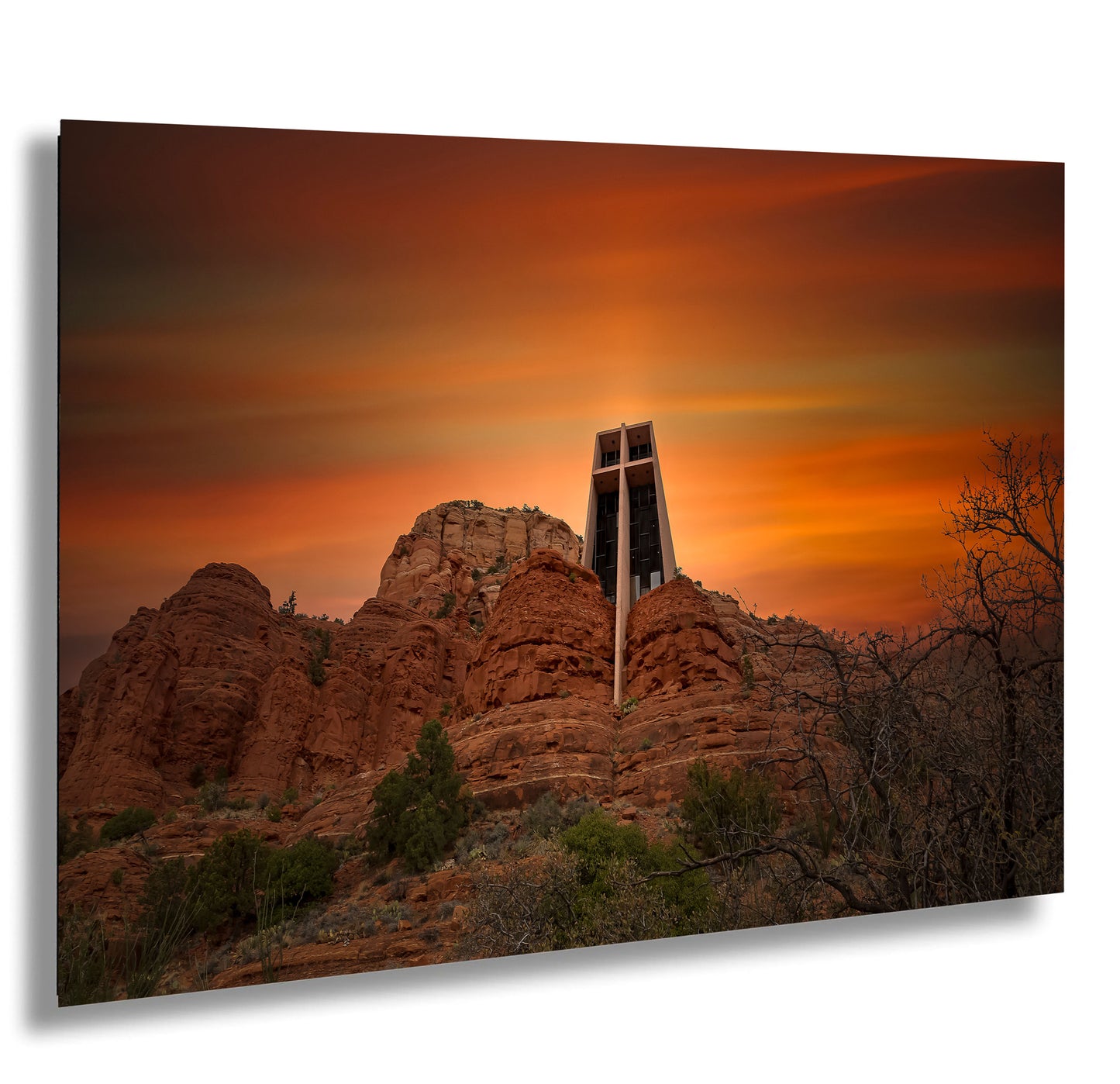 a cross on top of a mountain with a sunset in the background