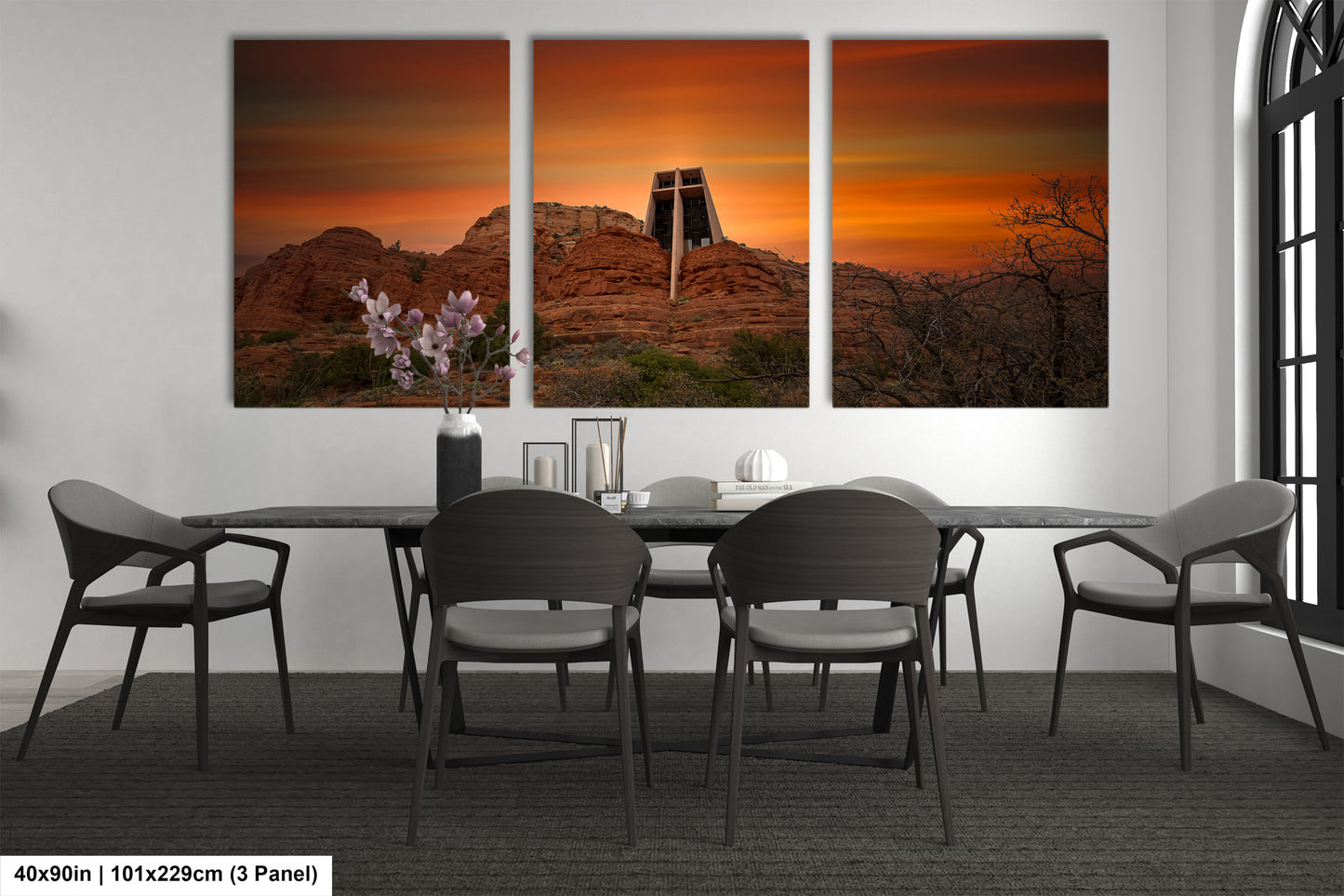 a dining room table with four chairs and a painting on the wall