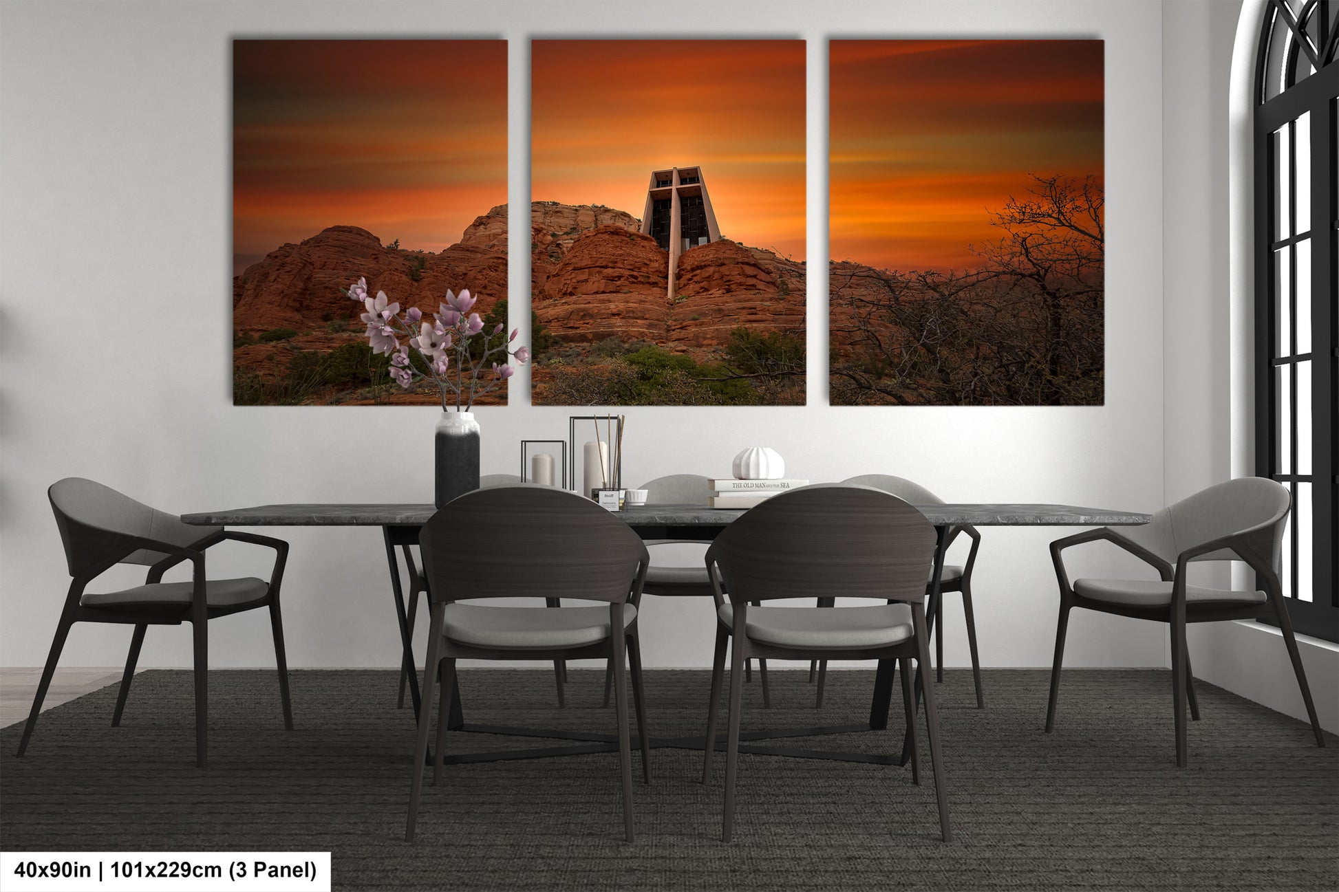 a dining room table with four chairs and a painting on the wall