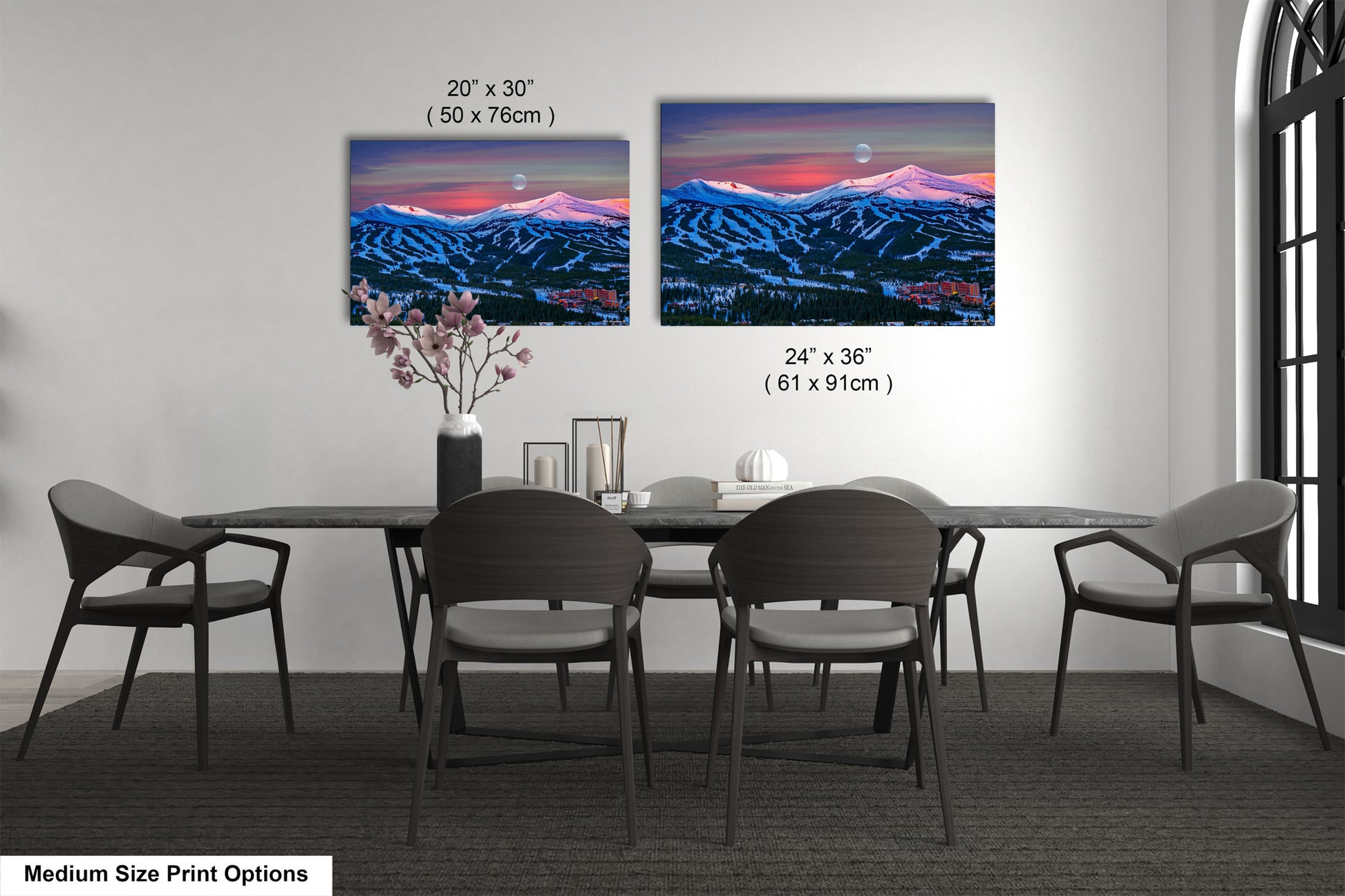 a dining table with four chairs and a vase of flowers