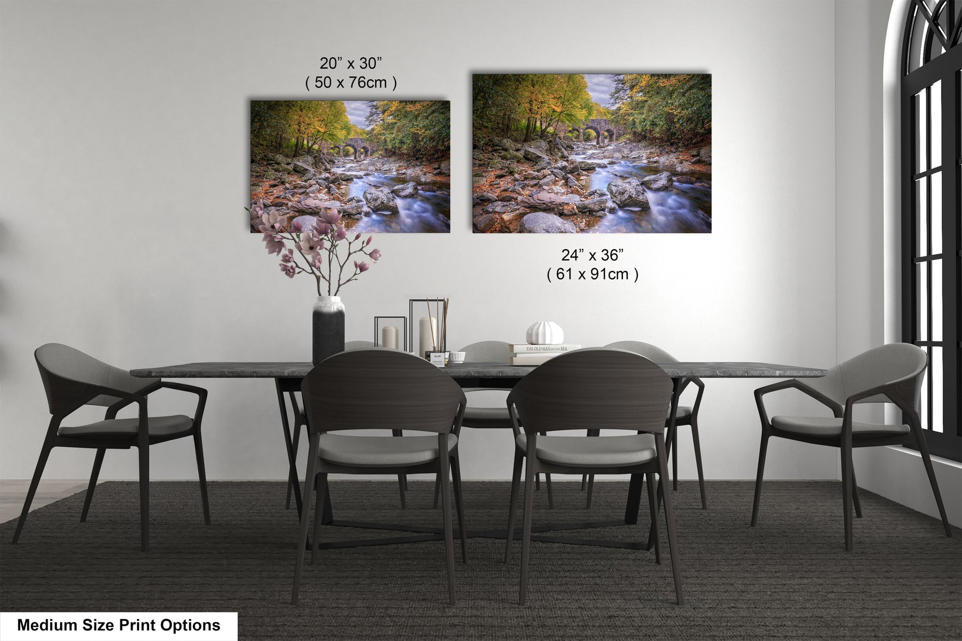 a dining table with four chairs and a vase of flowers
