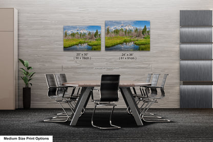 a dining room table with chairs next to a wall with a picture of a forest