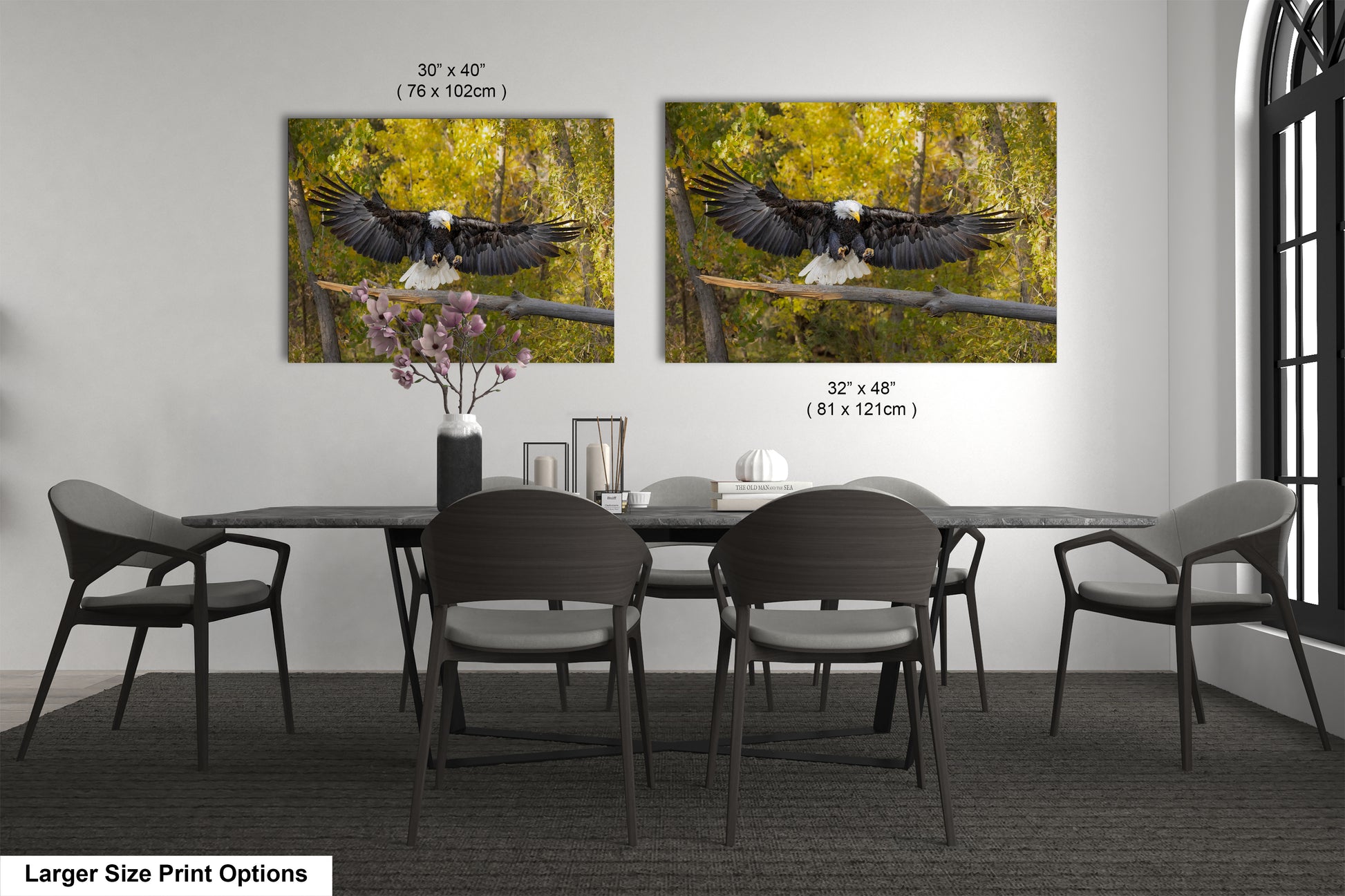 a dining room table with four chairs and two pictures of an eagle on the wall