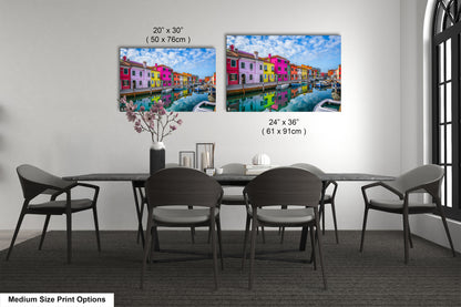 a dining room table with chairs and a vase of flowers