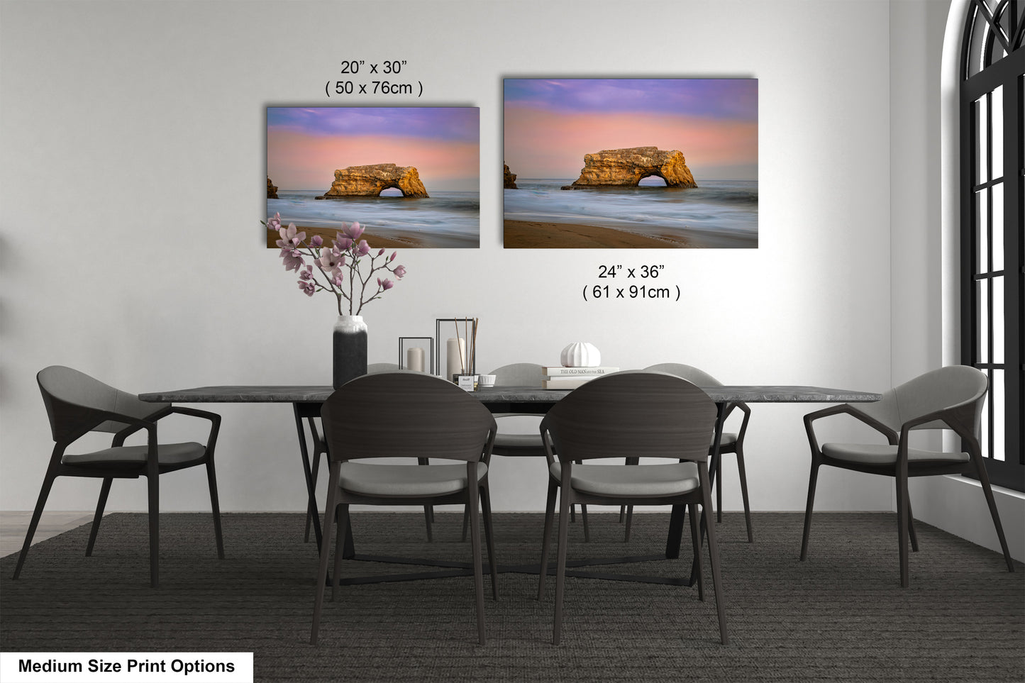 a dining room table with four chairs and a vase of flowers