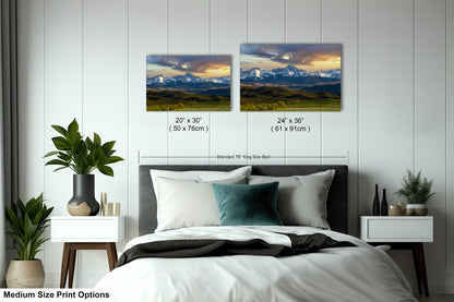 a bedroom with a bed, nightstands, and potted plants. There are two framed landscape photographs hanging on the wall above the bed, depicting a mountain range and a sunset. The photographs are of medium size, with dimensions of 20 x 30" (50 x 70") and 24 x 36" (61 x 91") respectively.