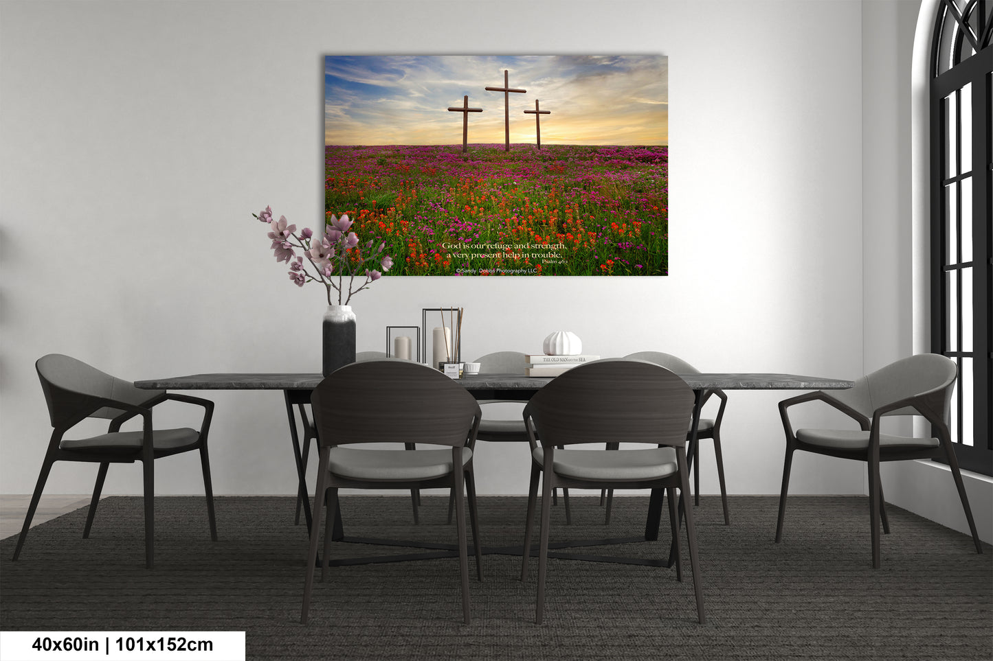 a room with a table and chairs and a painting on the wall
