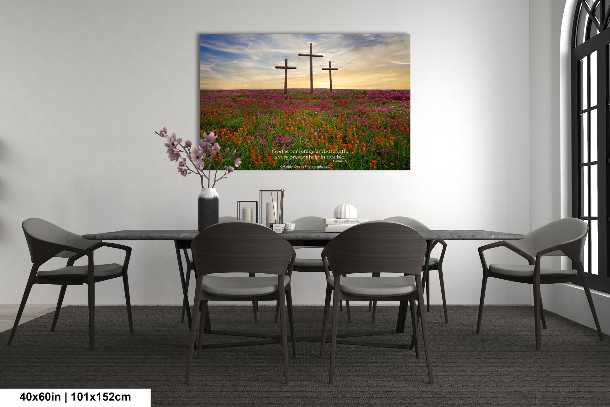 a room with a table and chairs and a painting on the wall