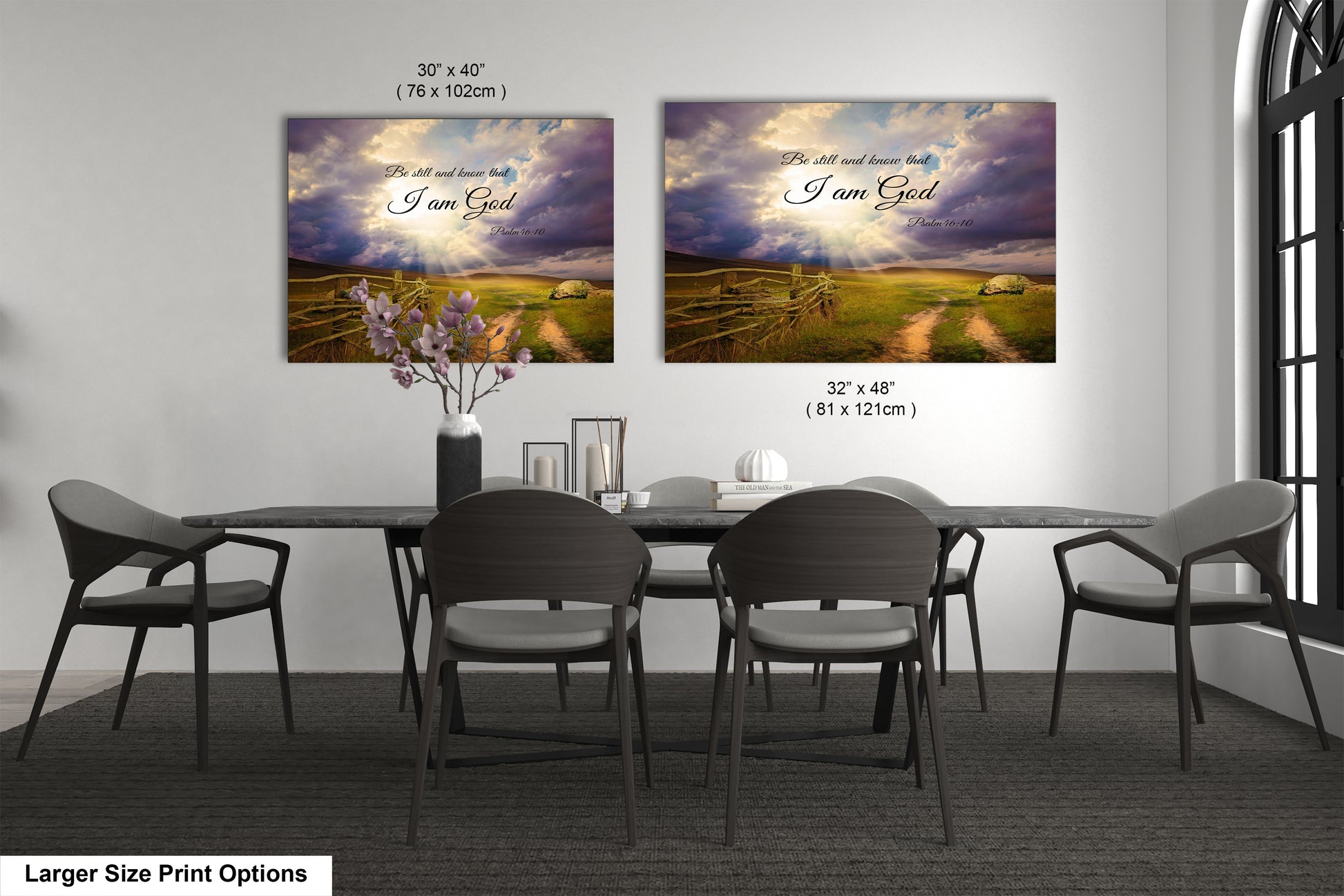 a dining room table with four chairs and two paintings on the wall