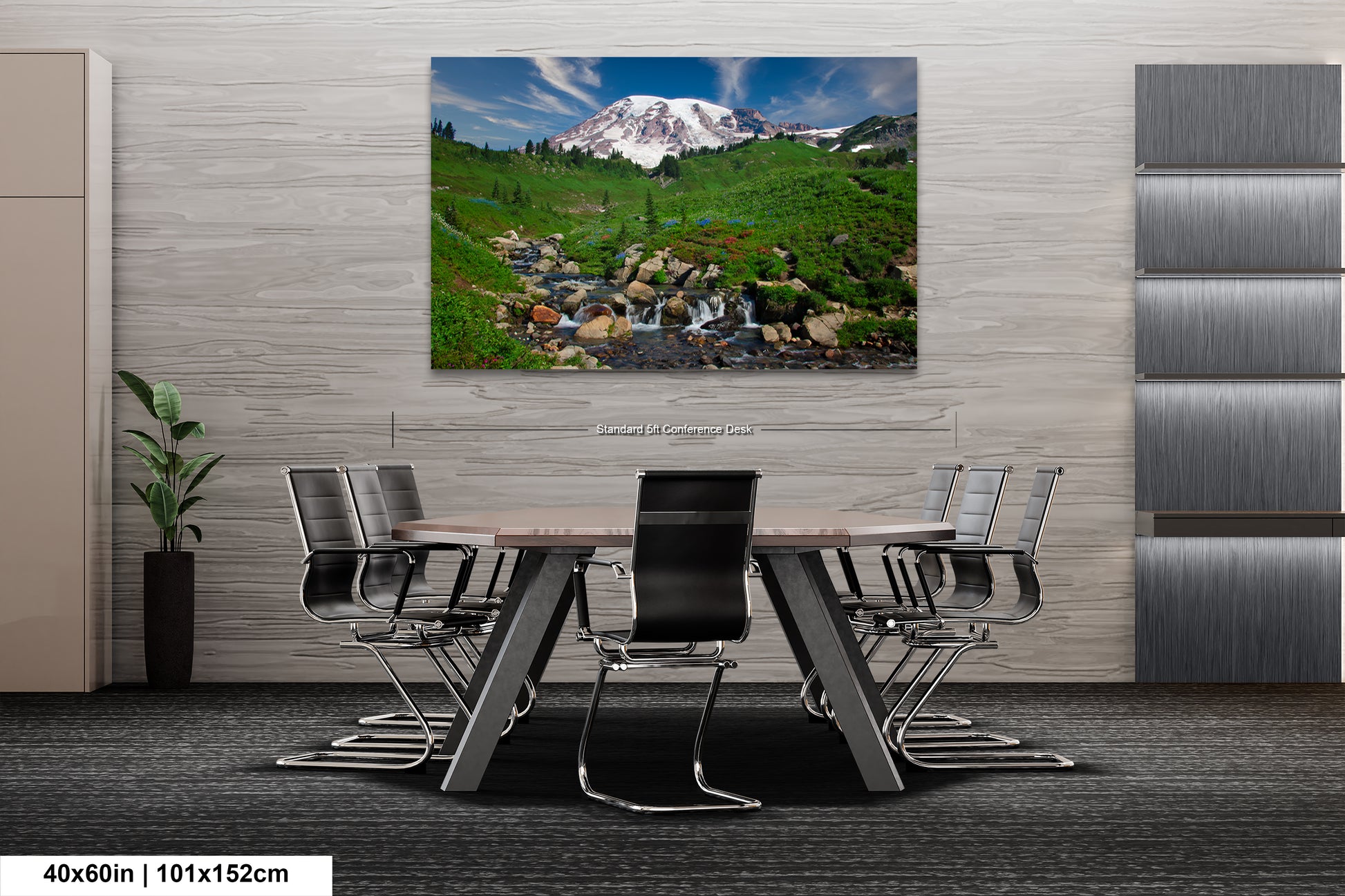 a dining room table with a painting of a mountain in the background