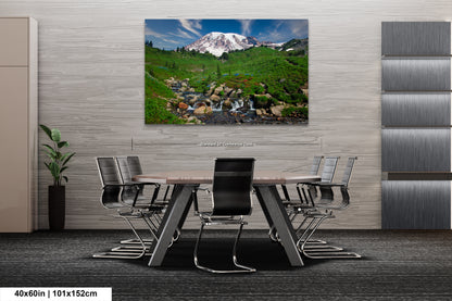 a dining room table with a painting of a mountain in the background