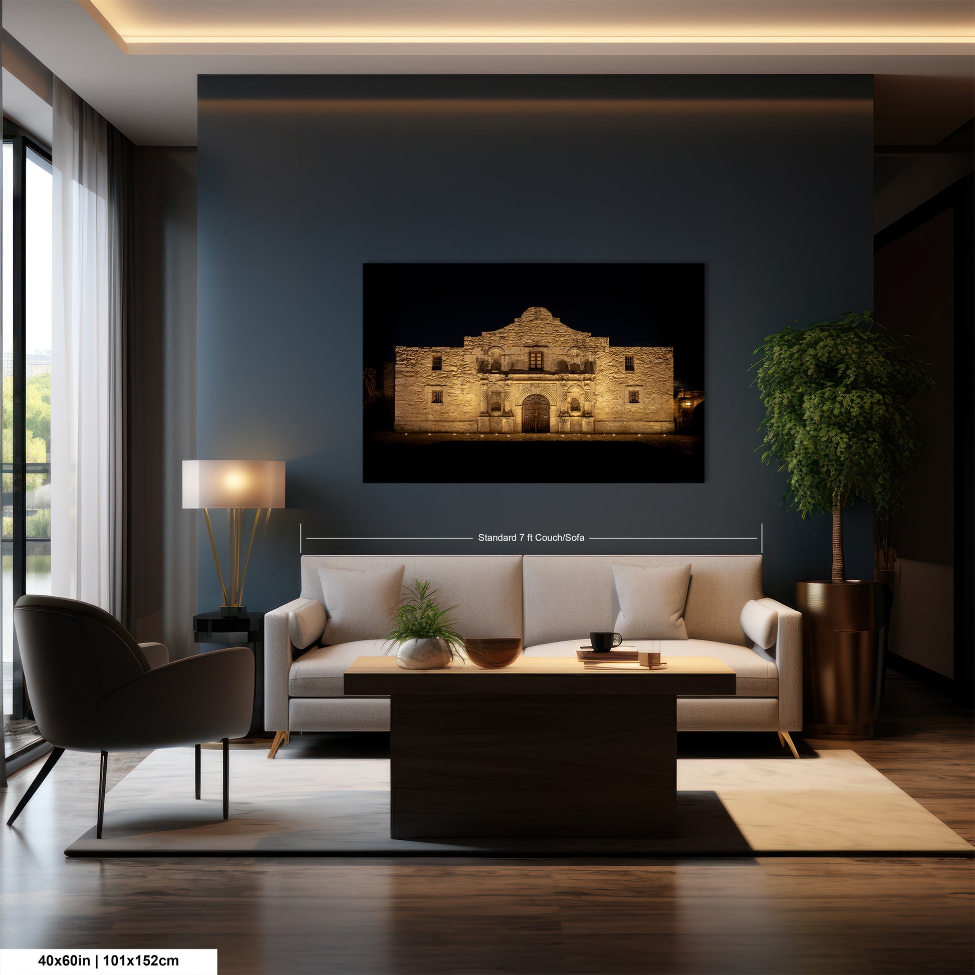 a modern living room with a large framed photograph of a historic building, likely the Alamo, hanging on the wall. The room is furnished with a sofa, a coffee table, and a chair, creating a comfortable and inviting atmosphere.
