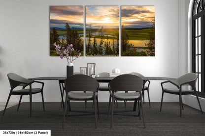 a dining room table with four chairs and a vase of flowers