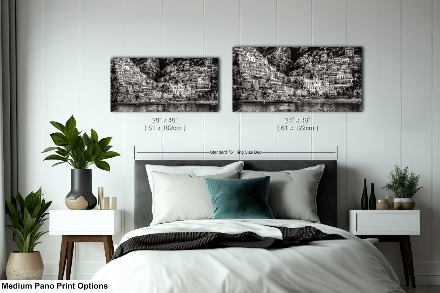 a bed with a white comforter and two black and white pictures on the wall