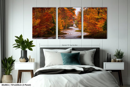 a bedroom with a bed and two paintings on the wall