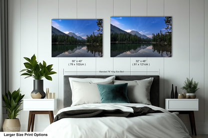 a bedroom with a bed and two pictures on the wall