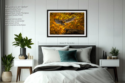 a bedroom with a bed and a picture hanging above it