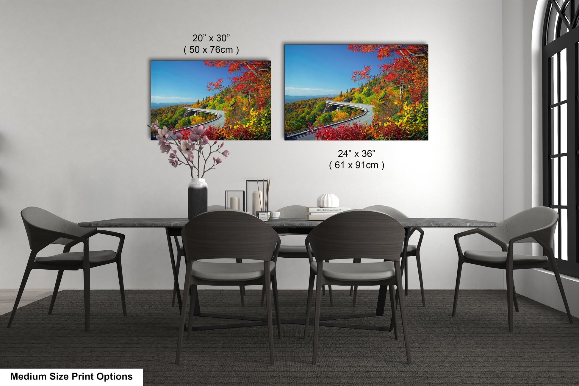 a dining table with four chairs and a vase of flowers