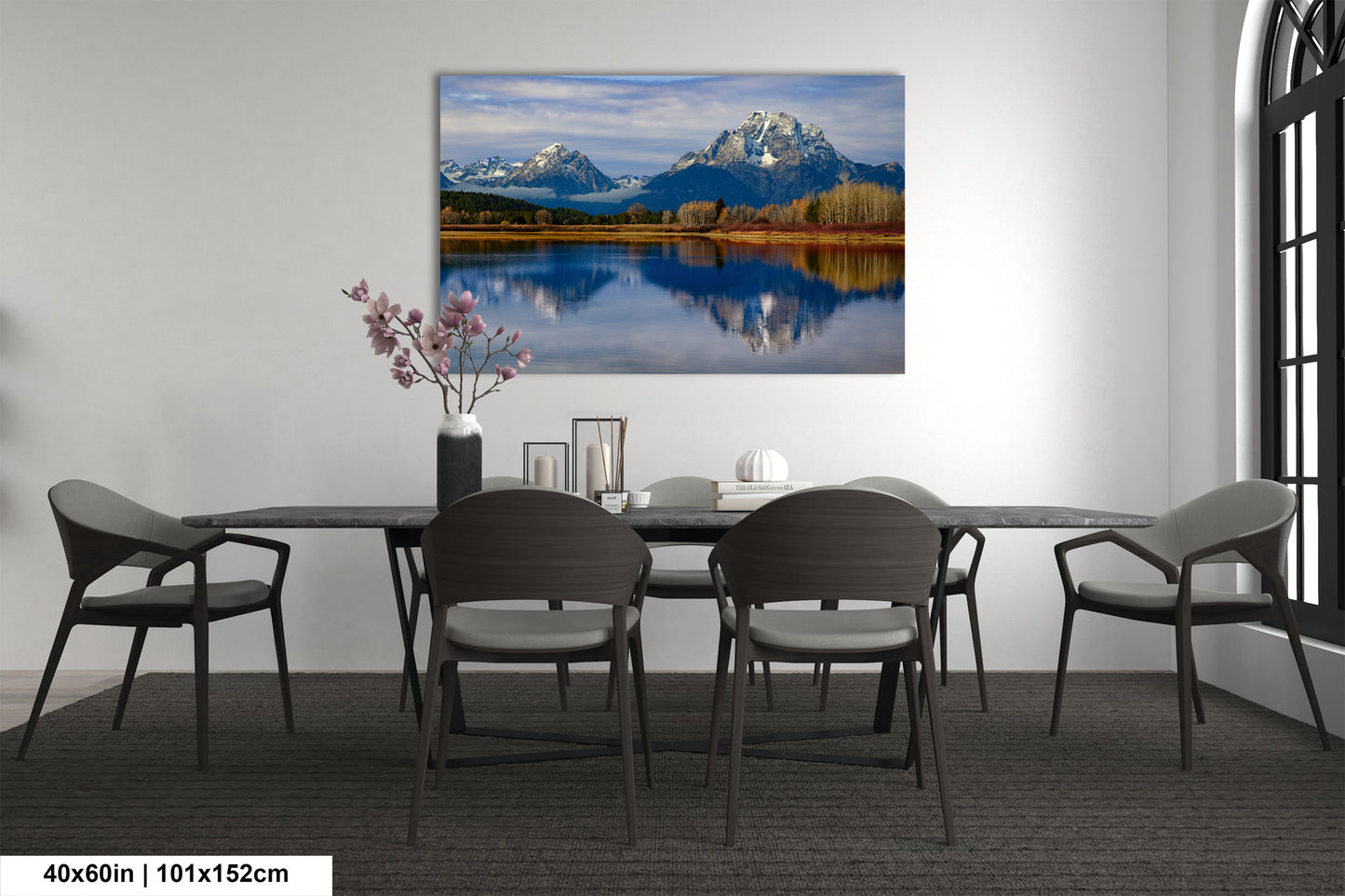 a dining room table with chairs and a painting on the wall