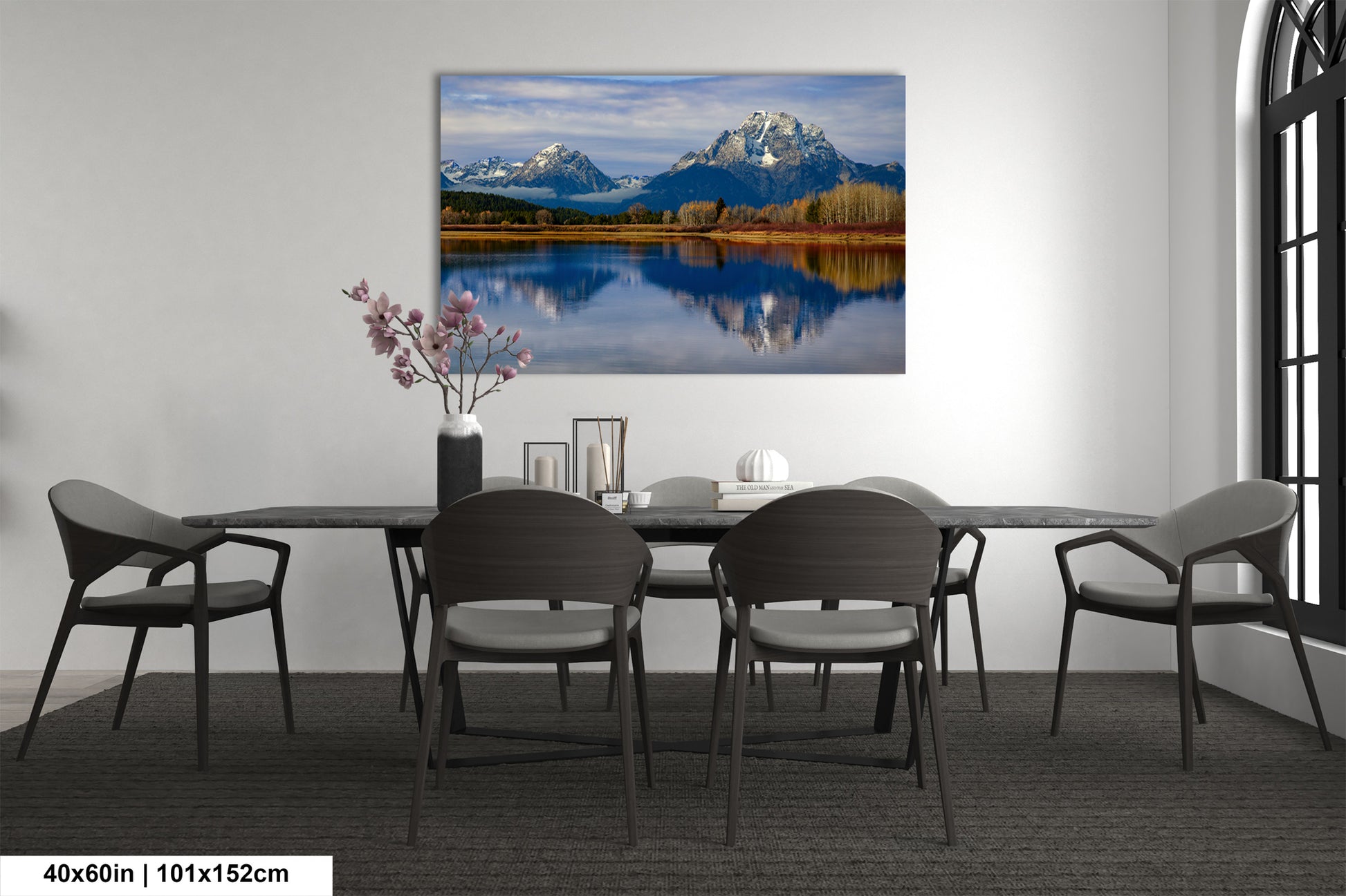 a dining room table with chairs and a painting on the wall