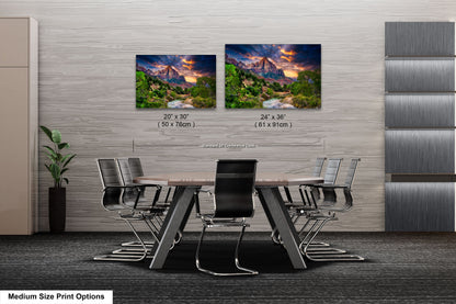 a dining room table with chairs next to a wall with pictures on it