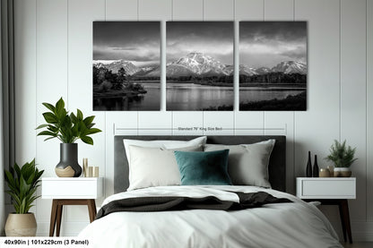 a black and white photo of a bed with a mountain range in the background