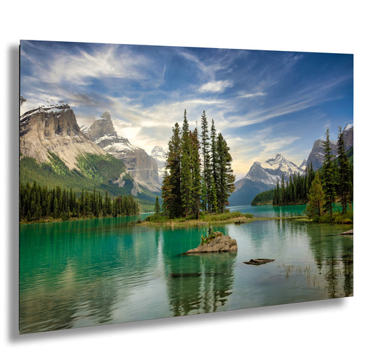 a lake surrounded by trees and mountains under a cloudy sky