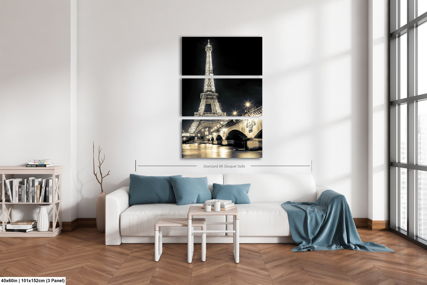 a living room with a white couch and three pictures of the eiffel tower