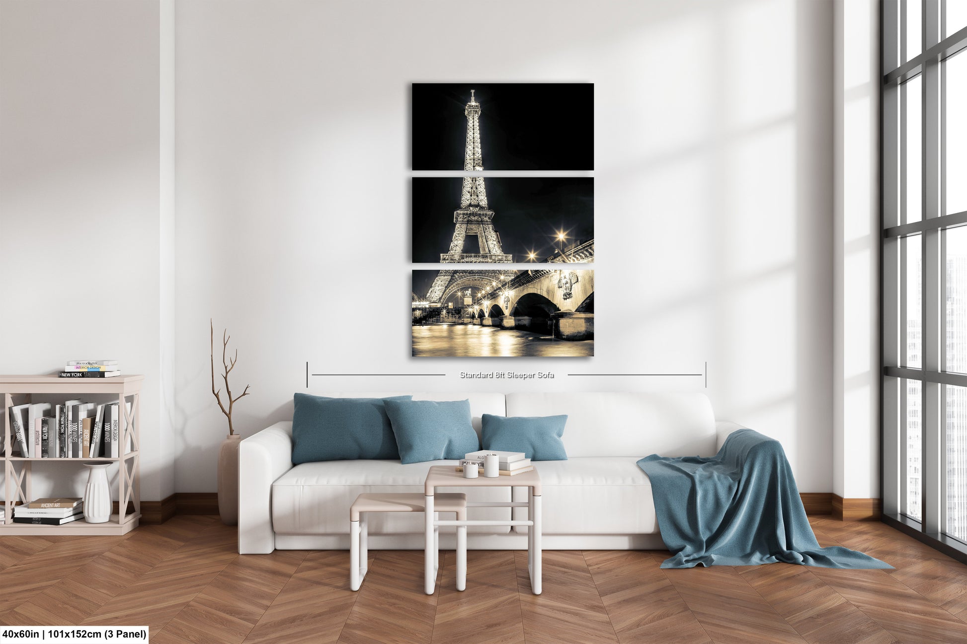 a living room with a white couch and three pictures of the eiffel tower