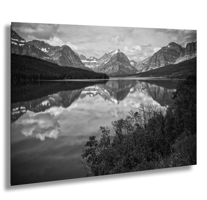 a black and white photo of a mountain lake