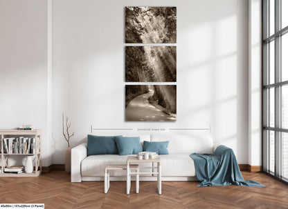 a living room with a white couch and three pictures on the wall