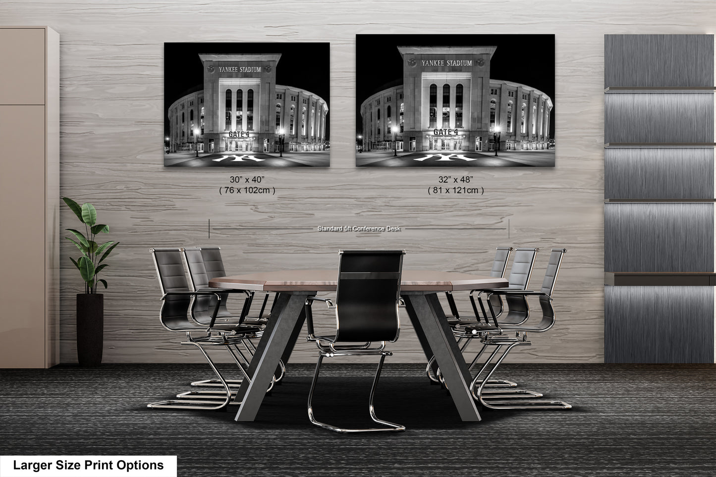 a modern office space with a large wooden table surrounded by black chairs. Two framed black and white photographs of Yankee Stadium are displayed on the wall above the table.
