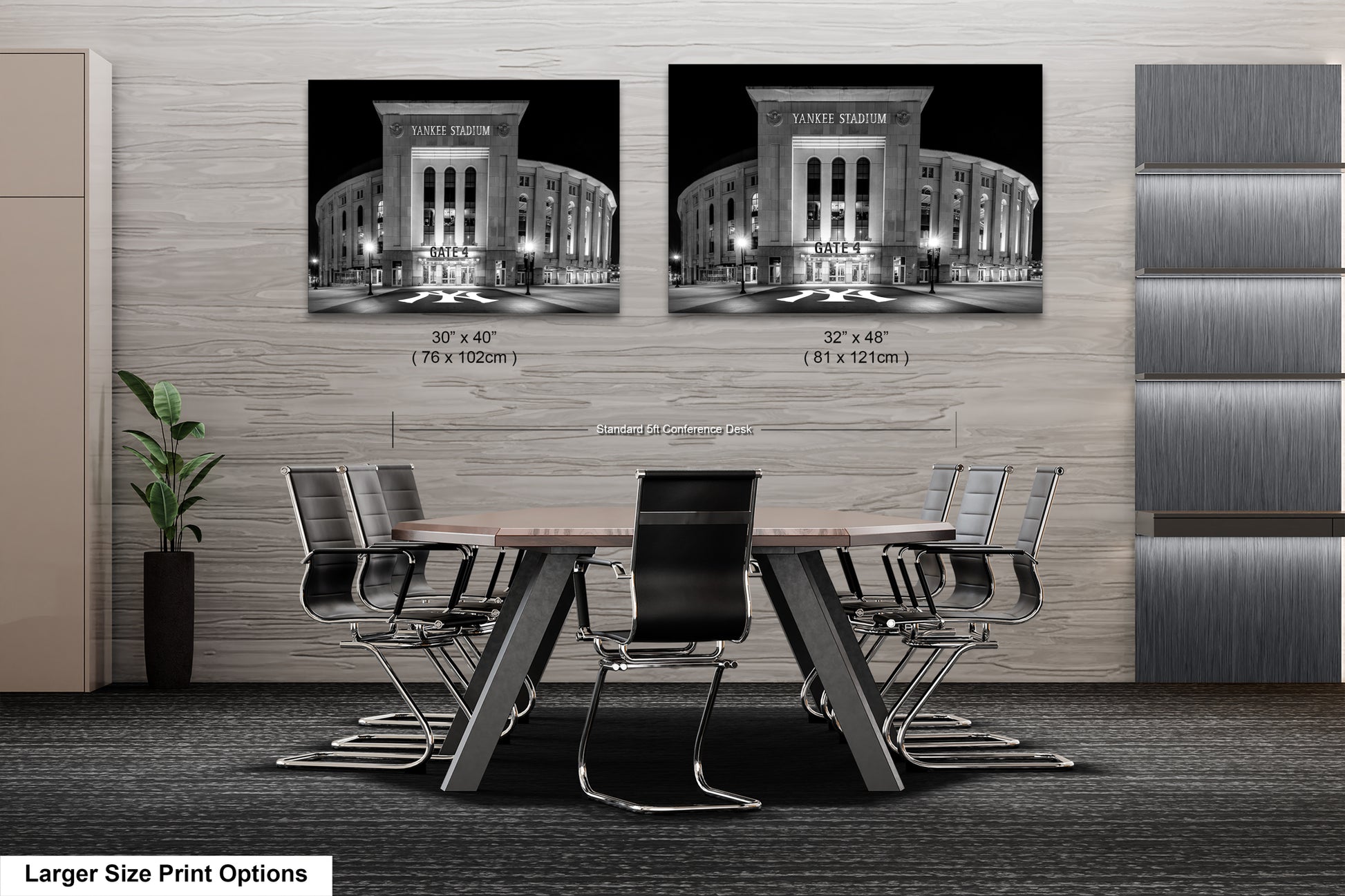 a modern office space with a large wooden table surrounded by black chairs. Two framed black and white photographs of Yankee Stadium are displayed on the wall above the table.