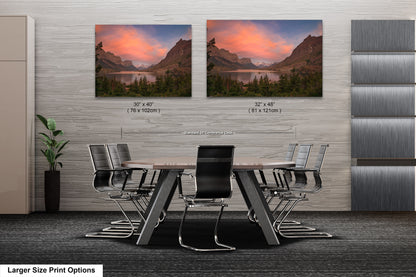 a dining room table with chairs and two pictures on the wall