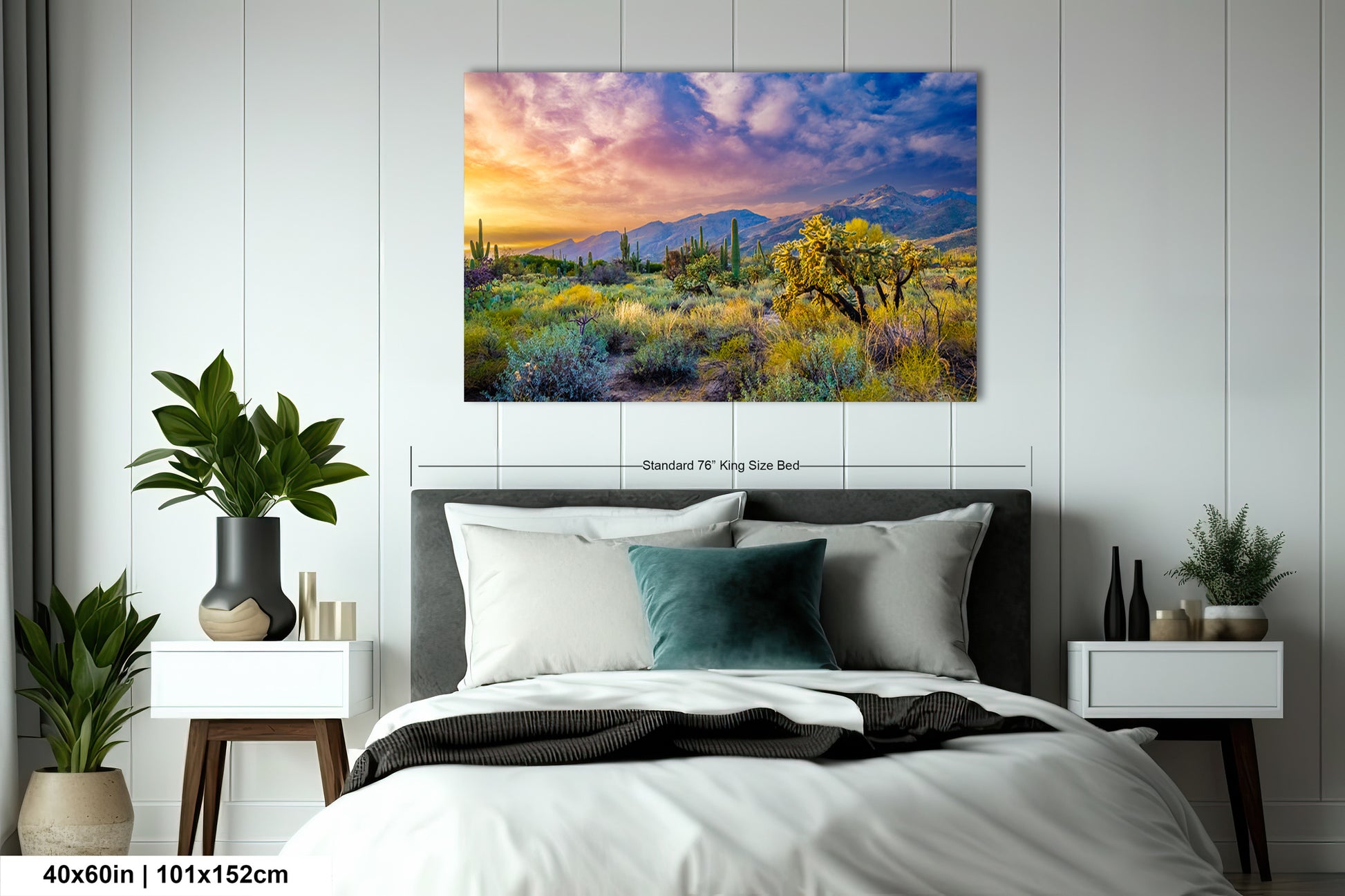 a painting of a desert scene on a wall above a bed
