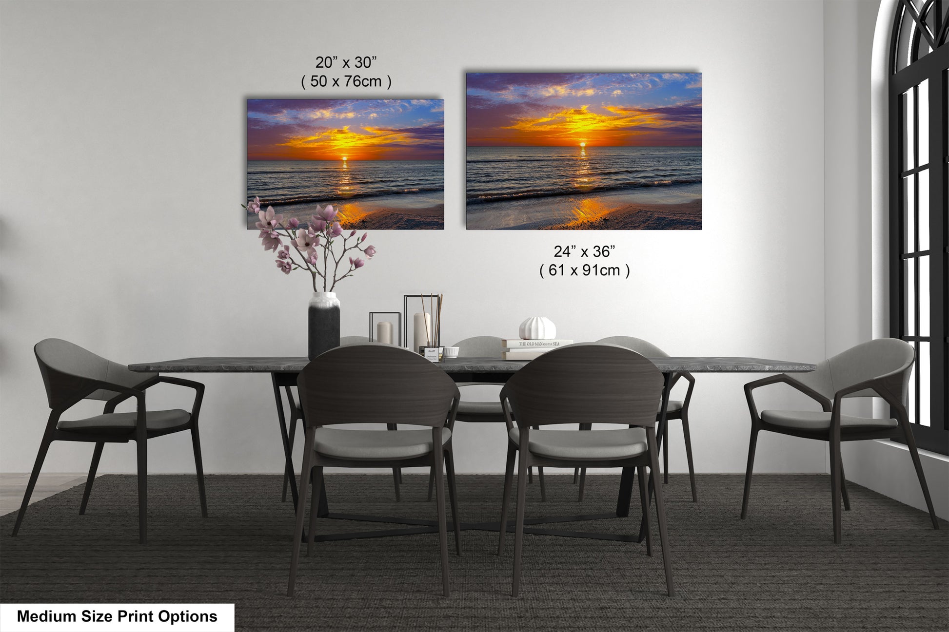a dining room table with four chairs and a vase of flowers