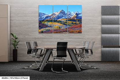 a dining room table with chairs and a painting on the wall