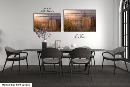 a dining table with four chairs and a vase of flowers