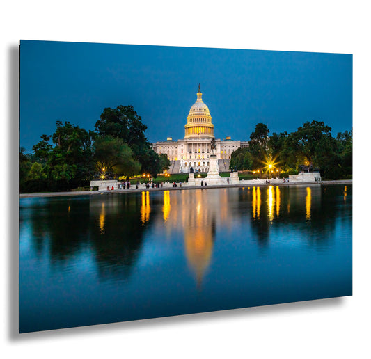 the capitol building reflecting in the water at night