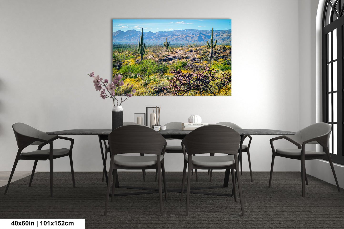 a desert landscape with mountains in the background, featuring cacti and other desert vegetation.