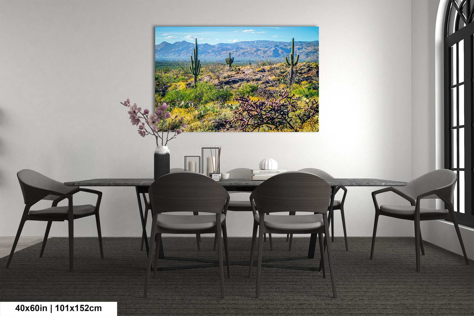 a desert landscape with mountains in the background, featuring cacti and other desert vegetation.