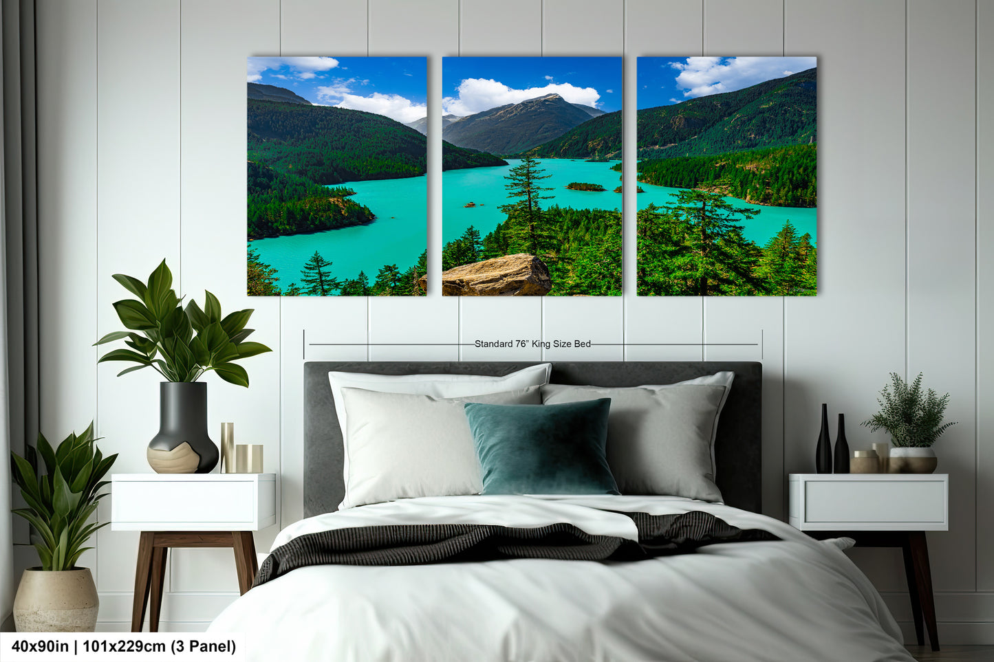 The image is a large bedroom with a bed, nightstands, and a large wall art depicting a scenic landscape with mountains, a lake, and trees.