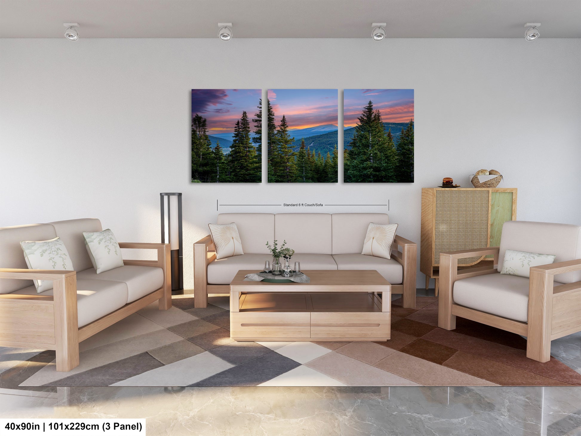 The image is a modern living room with a large, three-panel landscape painting hanging on the wall. The painting depicts a scenic mountain landscape with pine trees and a colorful sunset sky. The room is furnished with a sofa, two chairs, and a coffee table, creating a comfortable and inviting atmosphere.