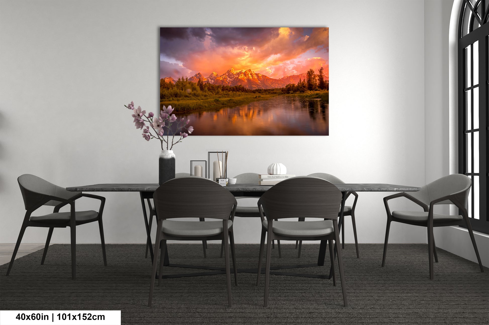 a dining room table with chairs and a painting on the wall