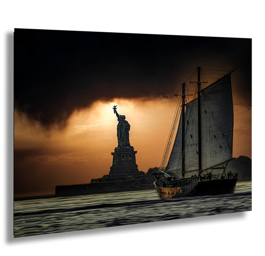 the statue of liberty is silhouetted against a cloudy sky