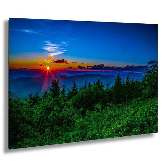 the sun is setting over a mountain range