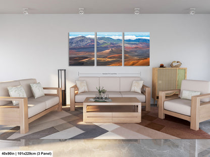 The image is a modern living room with a large, three-panel landscape painting hanging on the wall. The painting depicts a desert landscape with mountains in the background. The room is furnished with a sofa, two chairs, and a coffee table. The overall design and arrangement of the furniture and artwork create a cohesive and visually appealing space.