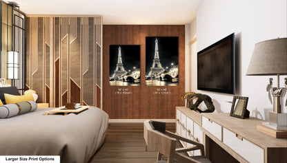 a room with a bed, desk, television and a picture of the eiff