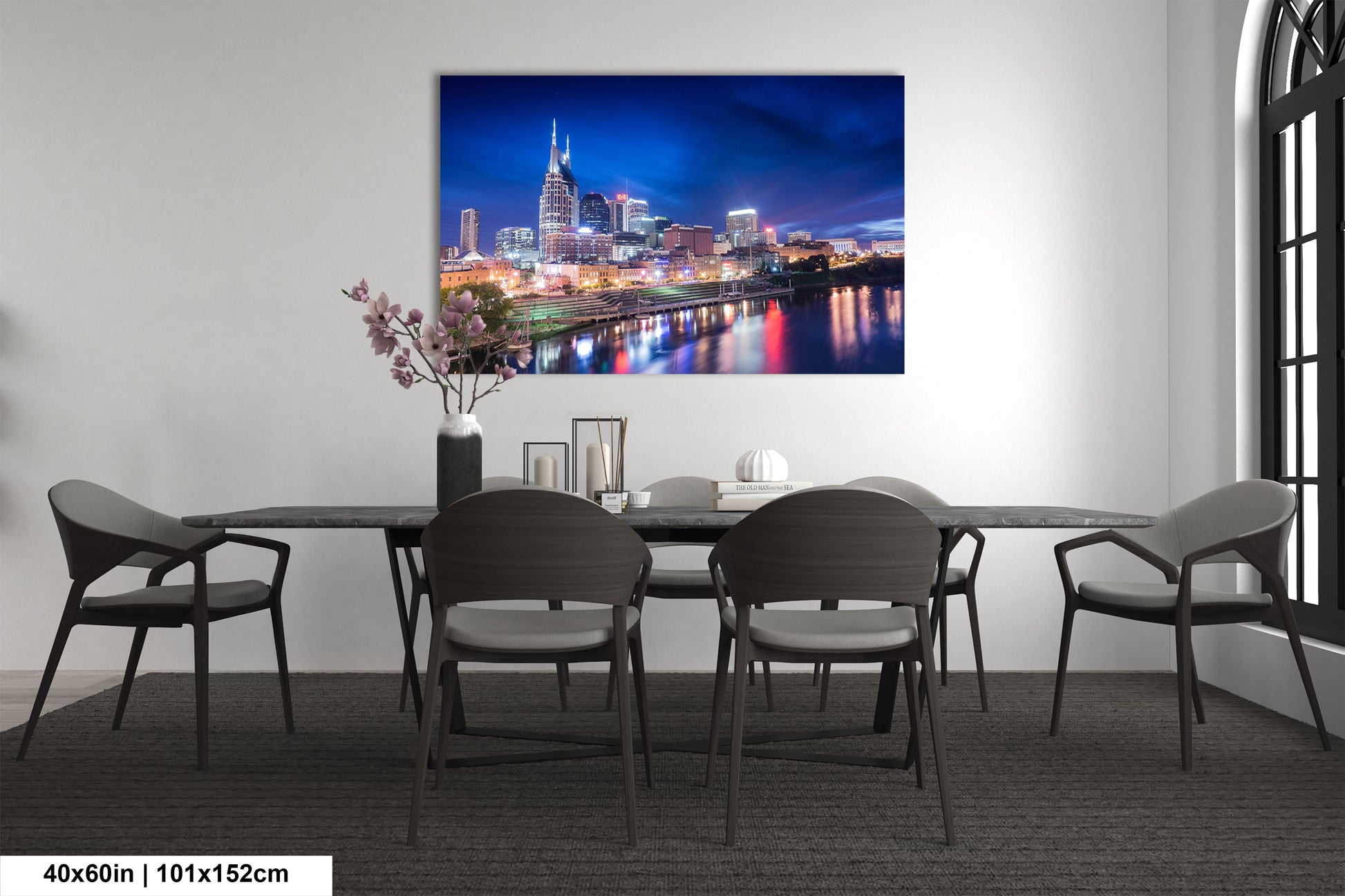 a room with a table and chairs and a painting on the wall