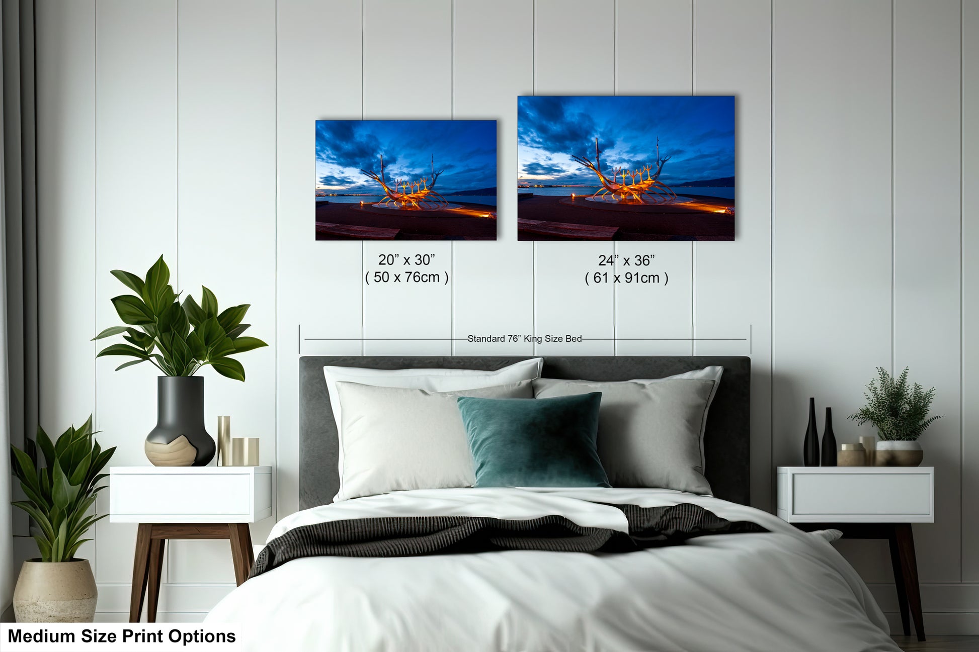 a bed with two pictures on the wall above it